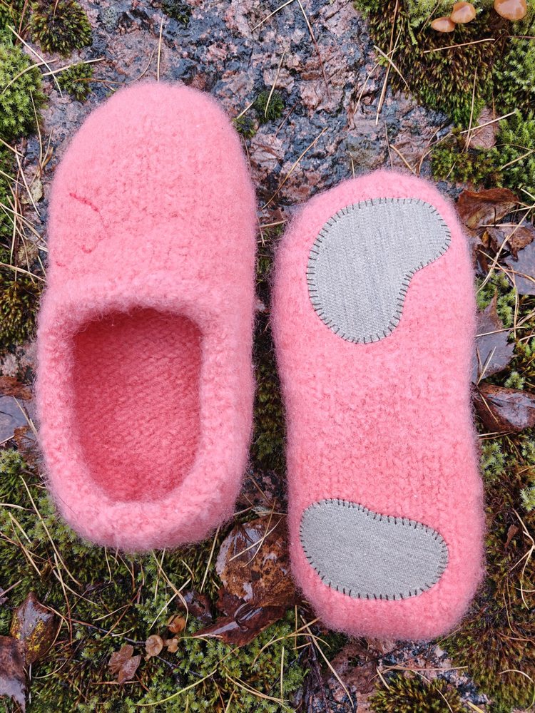 Pink Rahuu Devotion slippers with fabric soles on moss