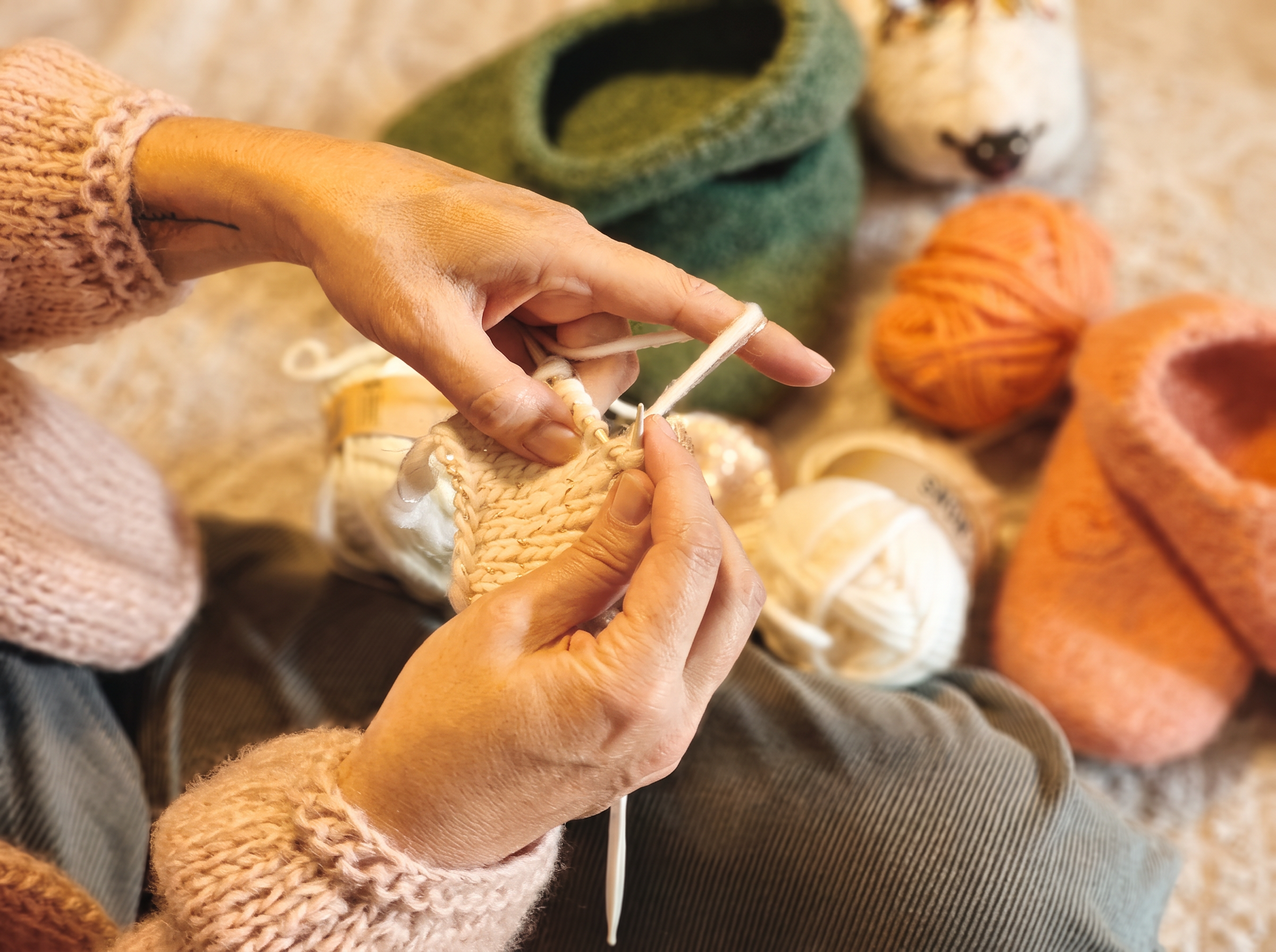 Hands knitting natural wool